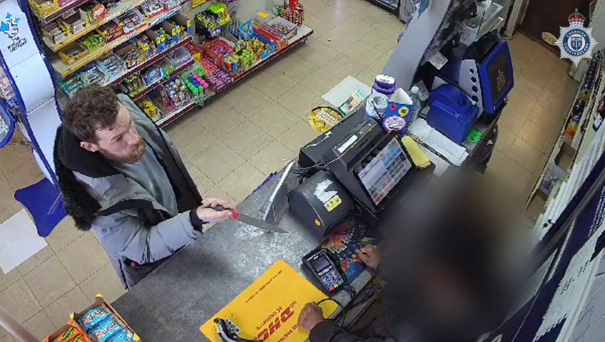 A CCTV still image of Peter Lea holding a knife 