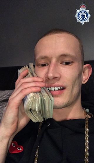 Damon Greenslade with cash and diamond teeth